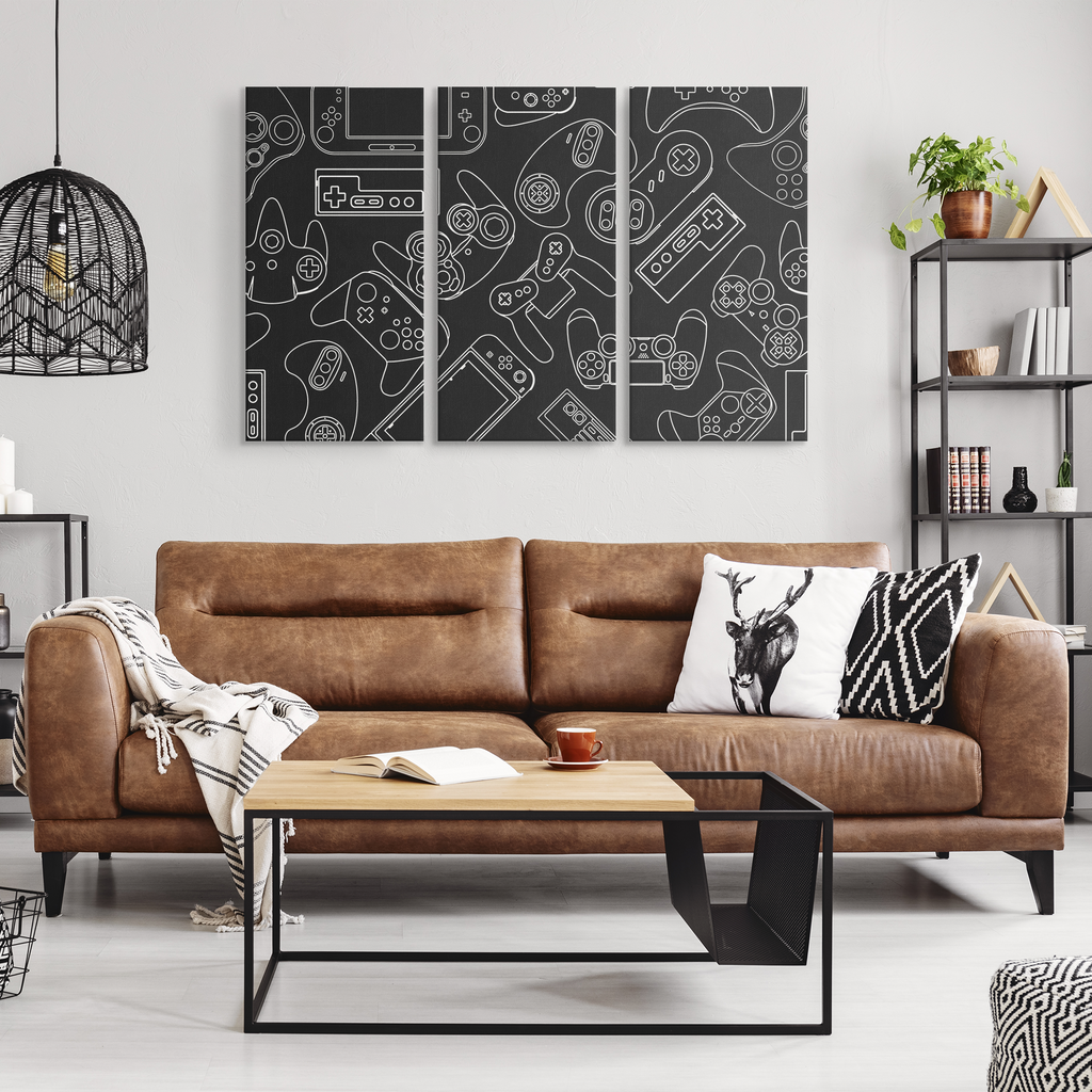 Three-panel video game controller canvas art displayed above a sofa