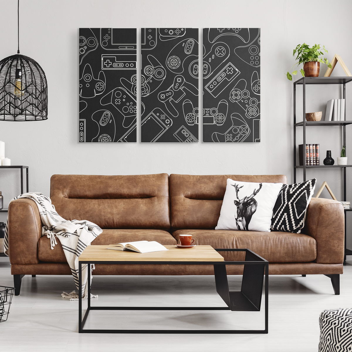 Three-panel video game controller canvas art displayed above a sofa
